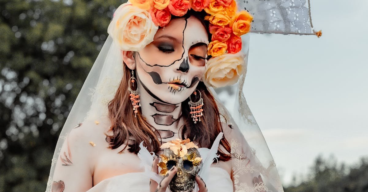 Woman in skeleton makeup and floral headdress celebrating Day of the Dead.