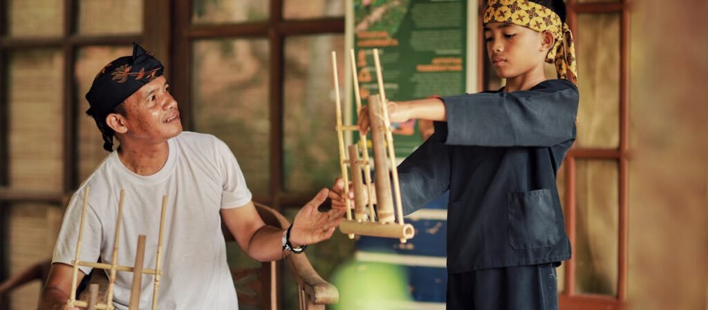 Angklung : A Man teaching how to play Angklung to his Child