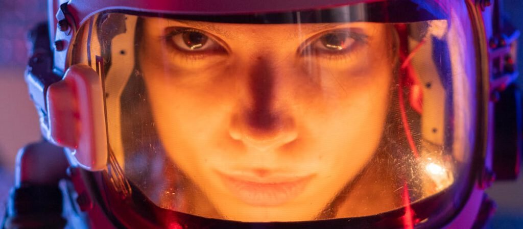 A focused female astronaut in a futuristic space suit, ready for interstellar exploration.