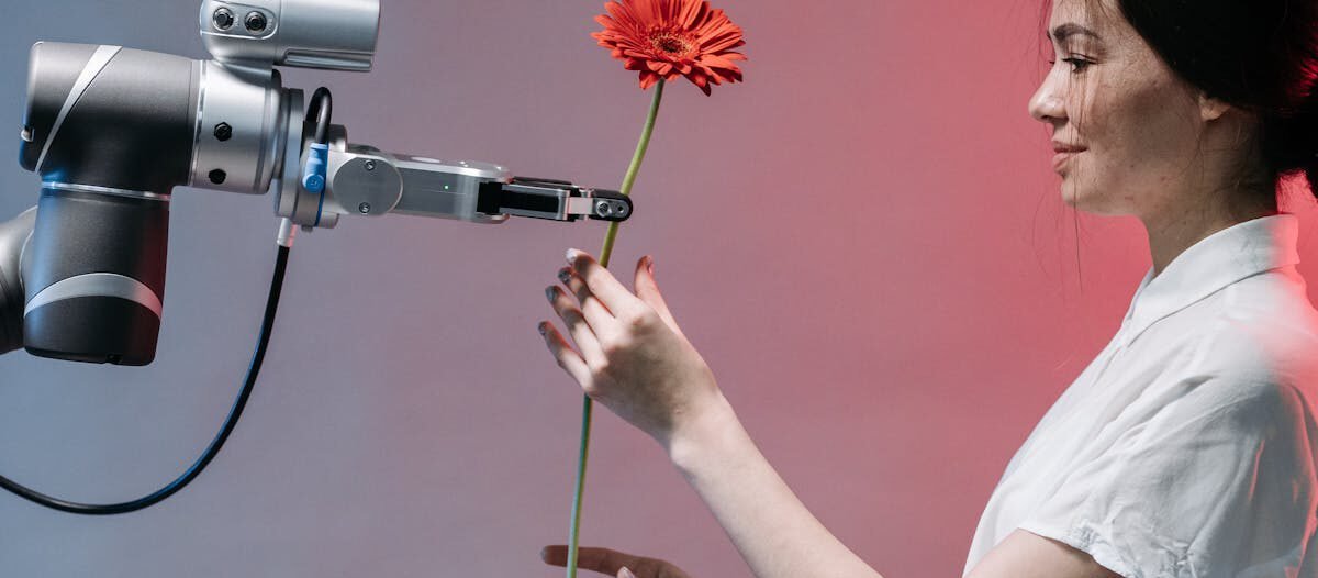 A woman interacts with a robotic arm holding a flower, symbolizing human-technology harmony.